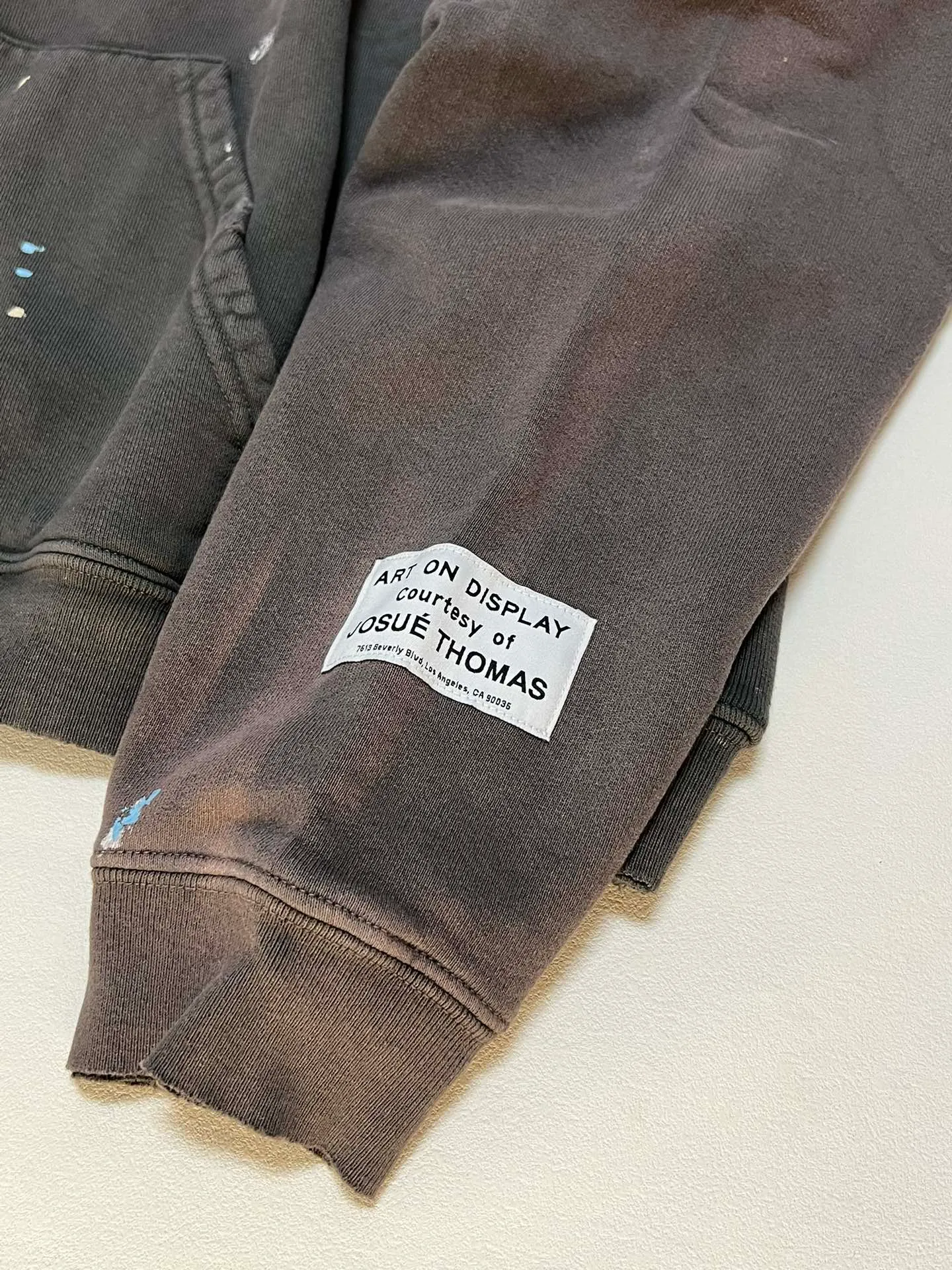 GALLERY DEPT. 90'S RECYCLE HOODIE WASHED BLACK 90'S washed hoodie with distressed eco-friendly slogans. Washed black S-XL. Ready-made garments are washed and dyed again. Multiple spots throughout the body are spray-faded. The ribs are cut and worn.